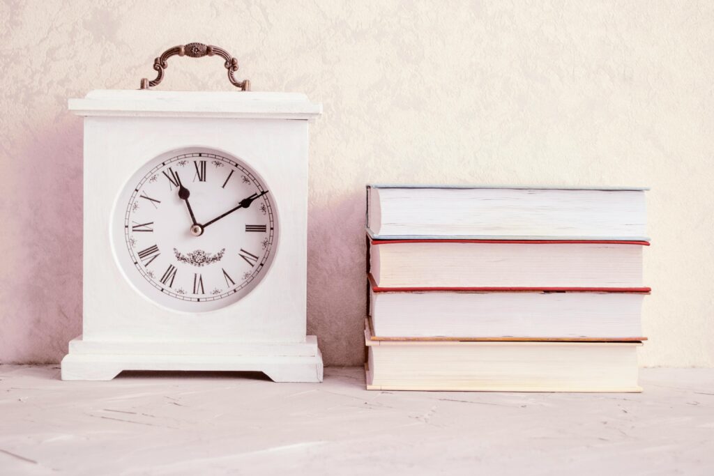 clock with books. time to sort your plan out